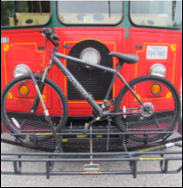 A red bus with a bike rack on the front, holding a bicycle